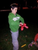 Chanukah on the Franklin Town Common: Sruly making animal-ballons for the other children